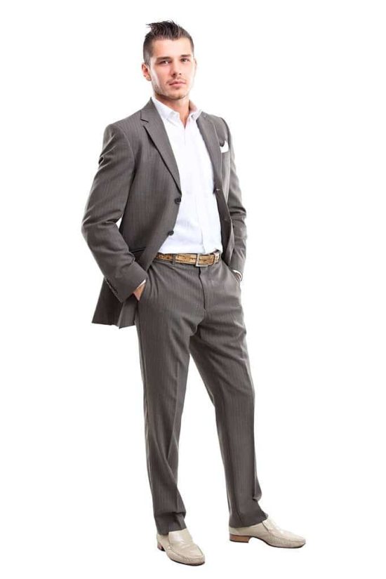 Full length of a handsome business man standing with hand in pocket against white background